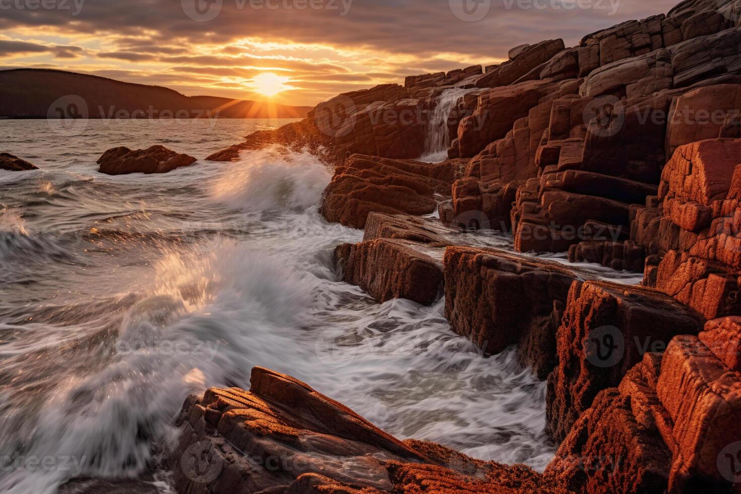 The waves are crashing over the rocks at sunset. photo