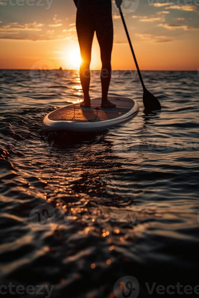 Stand up paddle boarding on quiet sea. photo