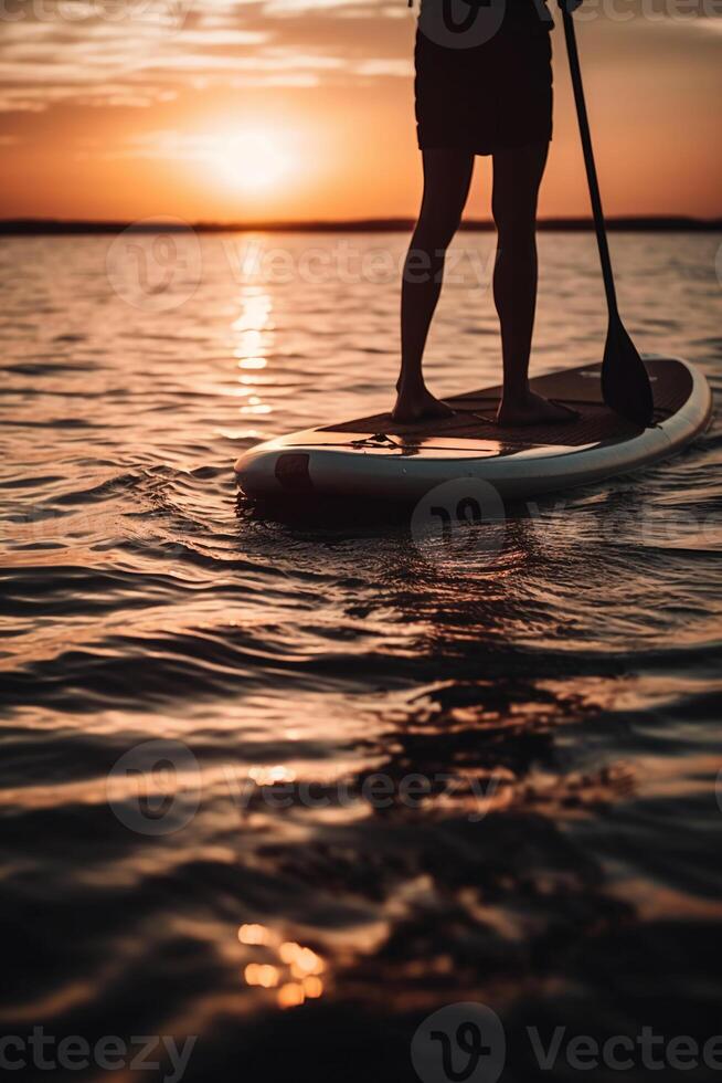 Stand up paddle boarding on quiet sea. photo