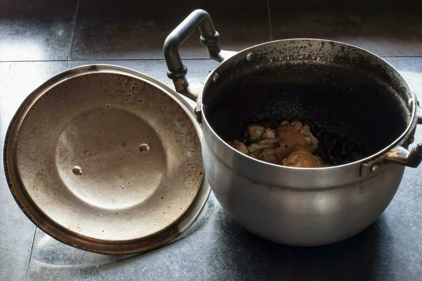 Pot of boiled pork bone soup burning until the water is dry and burnt. photo