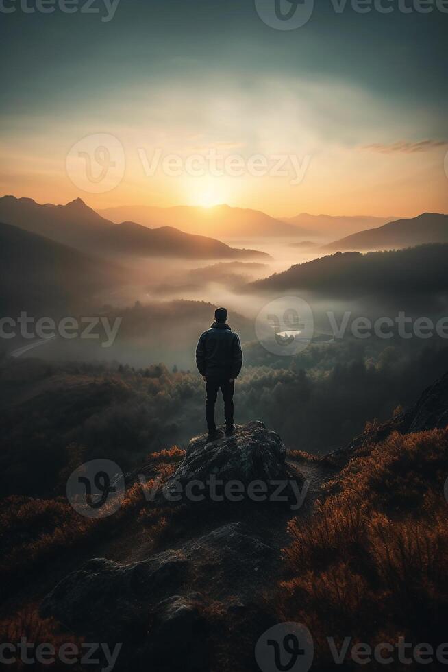 a man is standing on a mountain. photo