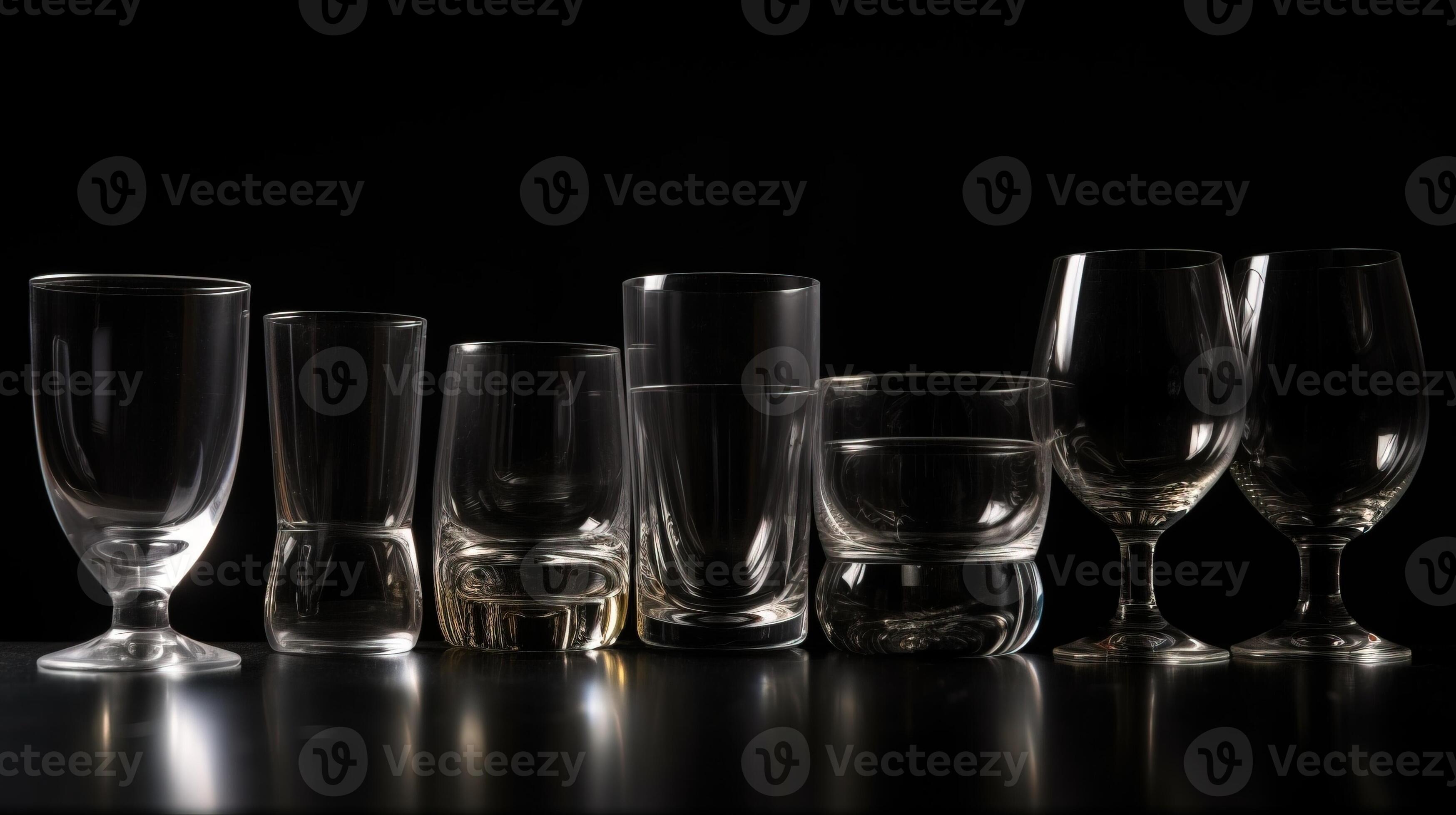 Various colored glasses for different drinks in a row, black background