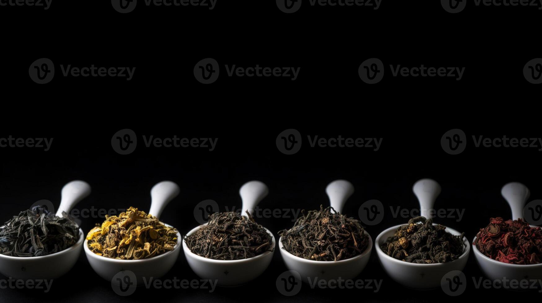 Types of tea in a cup and leaves, healing tonic drink, black background isolate. . photo
