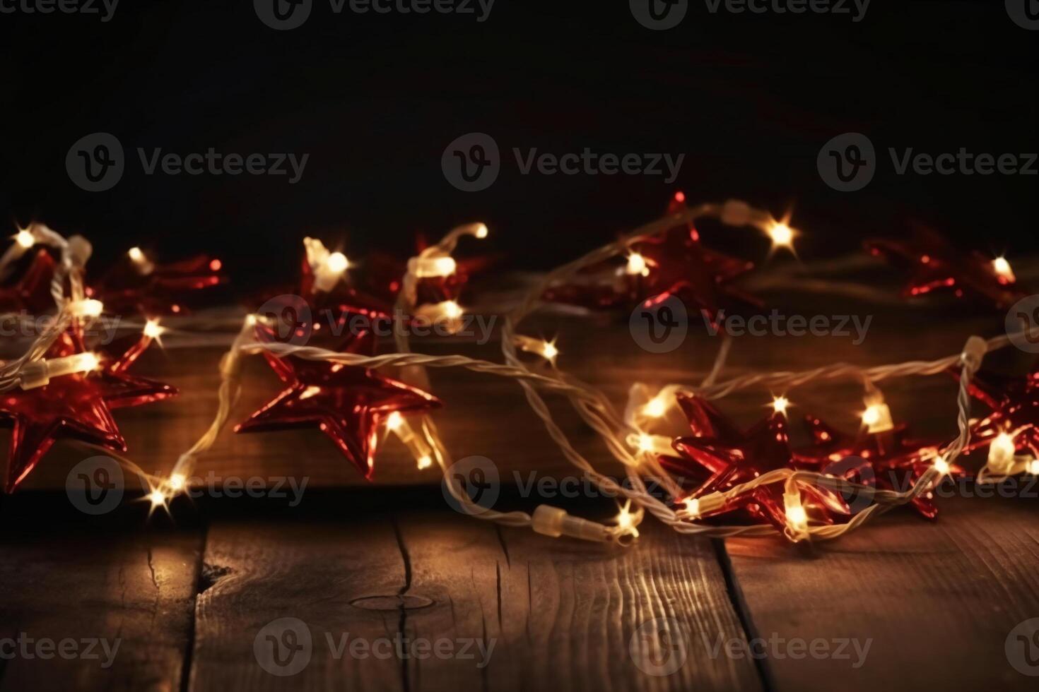 Christmas background with blue light luminous garlands and red stars on a white wooden background with copy space. photo
