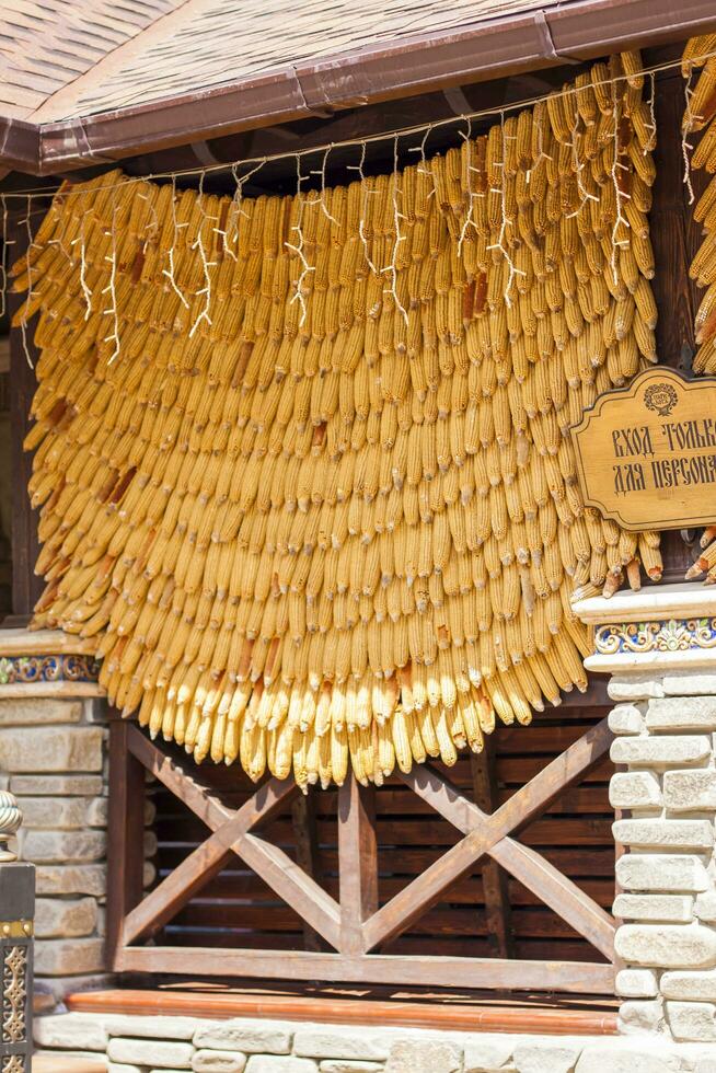 2021-05-07. Russia. Kamensk-Shakhtinsky, Rostov region. Beautiful decor elements in the park for tourists. A canopy on a building made of corn cobs. photo