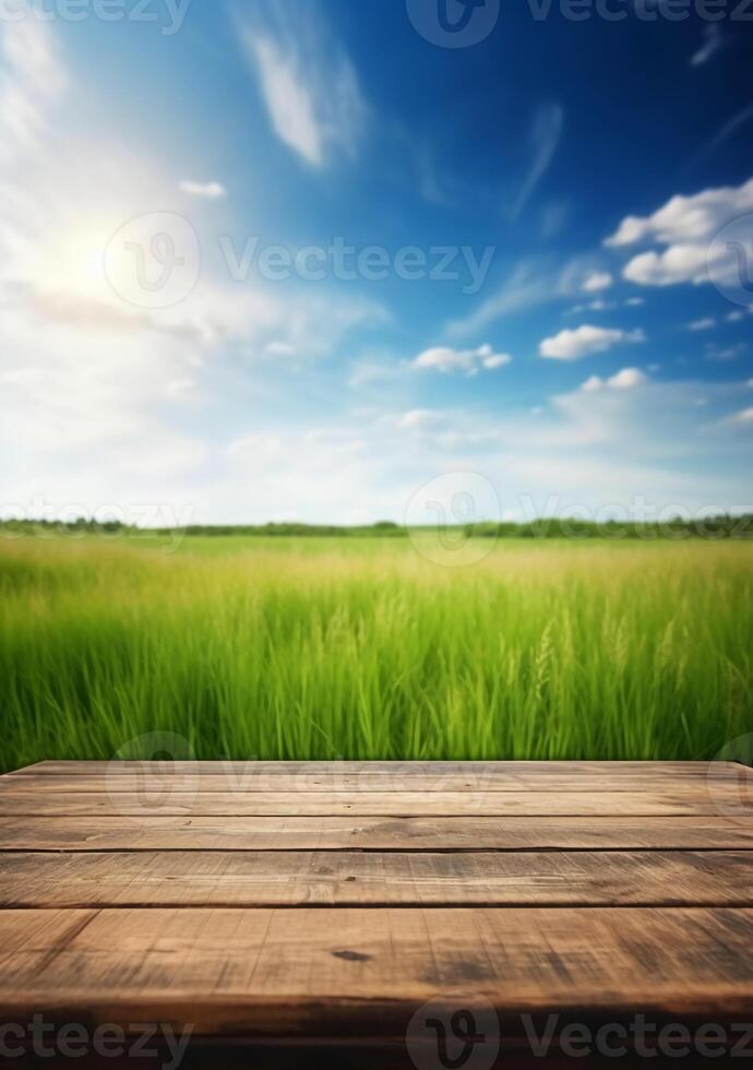 Spring summer beautiful background with green juicy young grass and empty wooden table in nature outdoor. Natural template landscape with blue sky and sun. photo