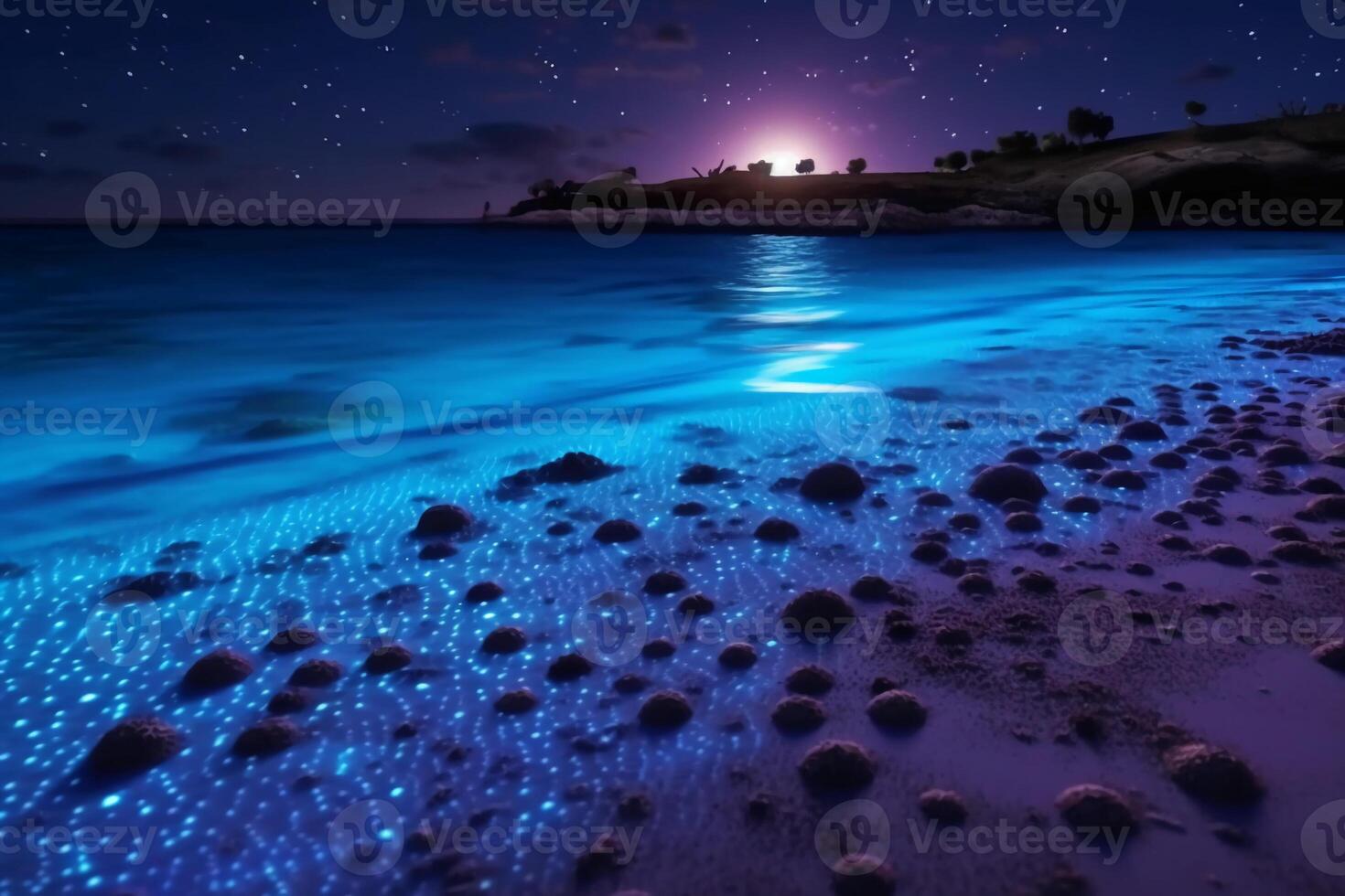 Ocean shore at night, the water is full of dinoflagellates, glowing with millions bright blue neon glow in the dark tiny dots. photo