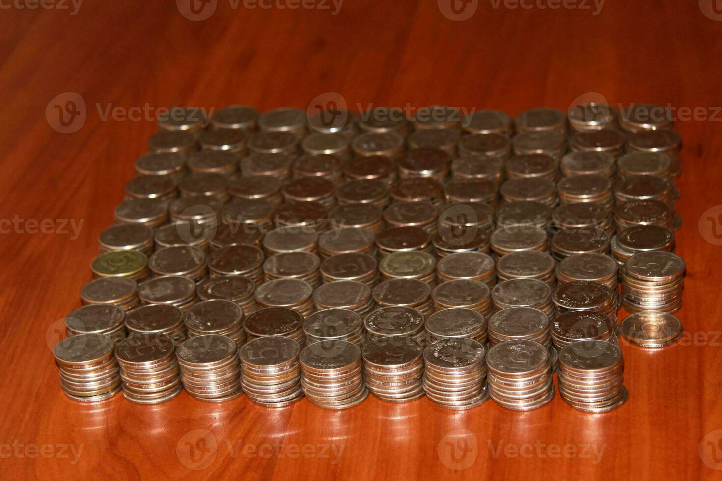 Moscow, 2012-10-15, Five-ruble coins are lying on the table in neat piles. photo