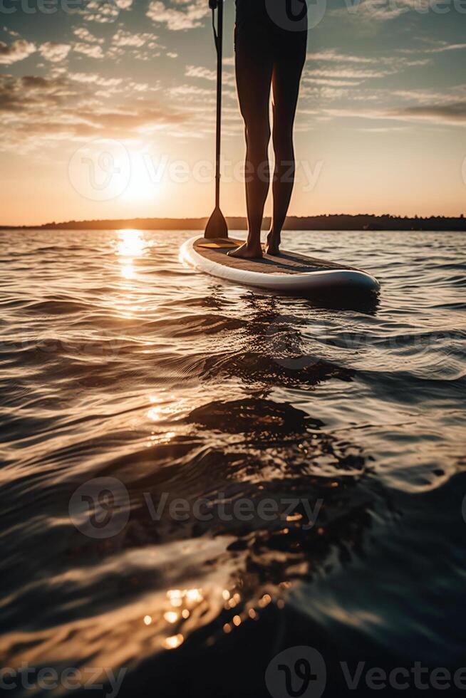 Stand up paddle boarding on quiet sea. photo