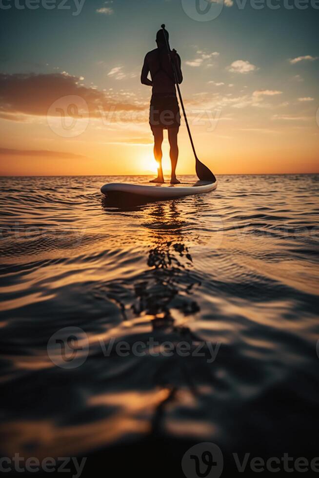 Stand up paddle boarding on quiet sea. photo