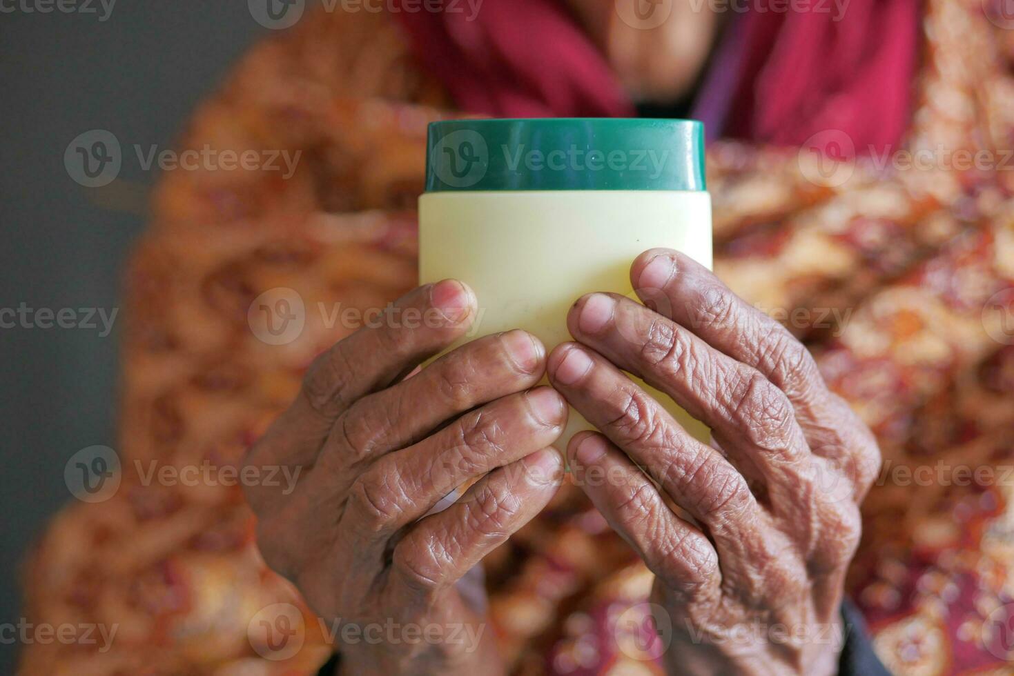 elderly woman using petroleum jelly photo