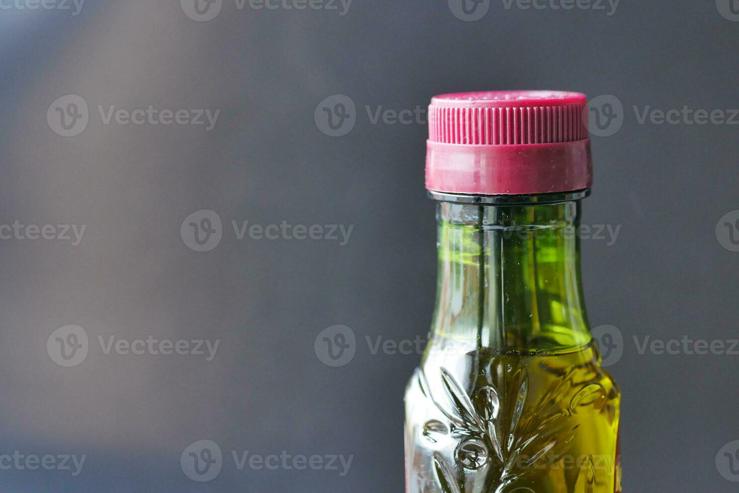 bottle of olive oil against black background photo