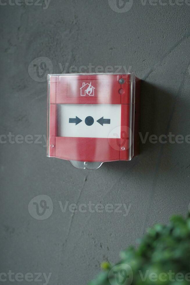 Red fire alarm button on wall , photo