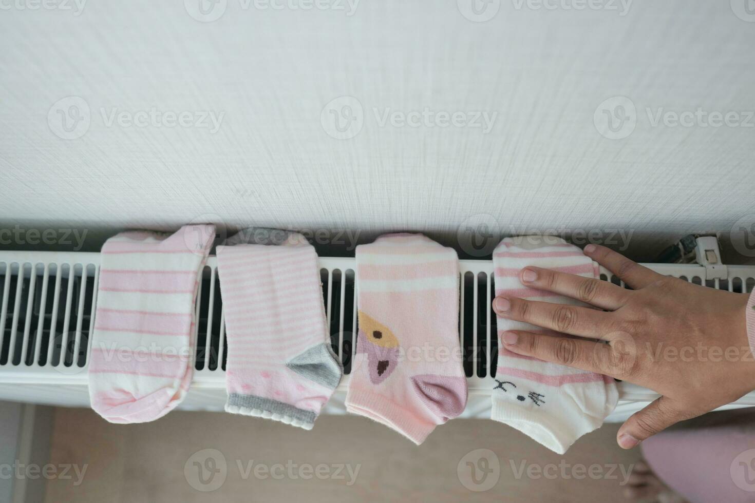 sock drying on heating radiator, photo