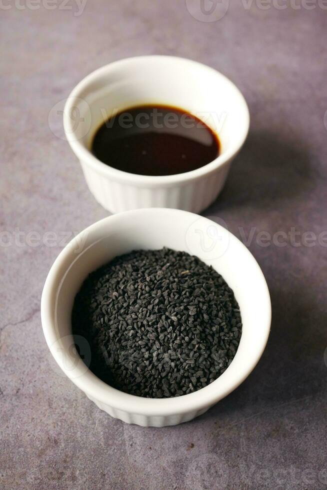 Black Cumin seed in a container on table photo