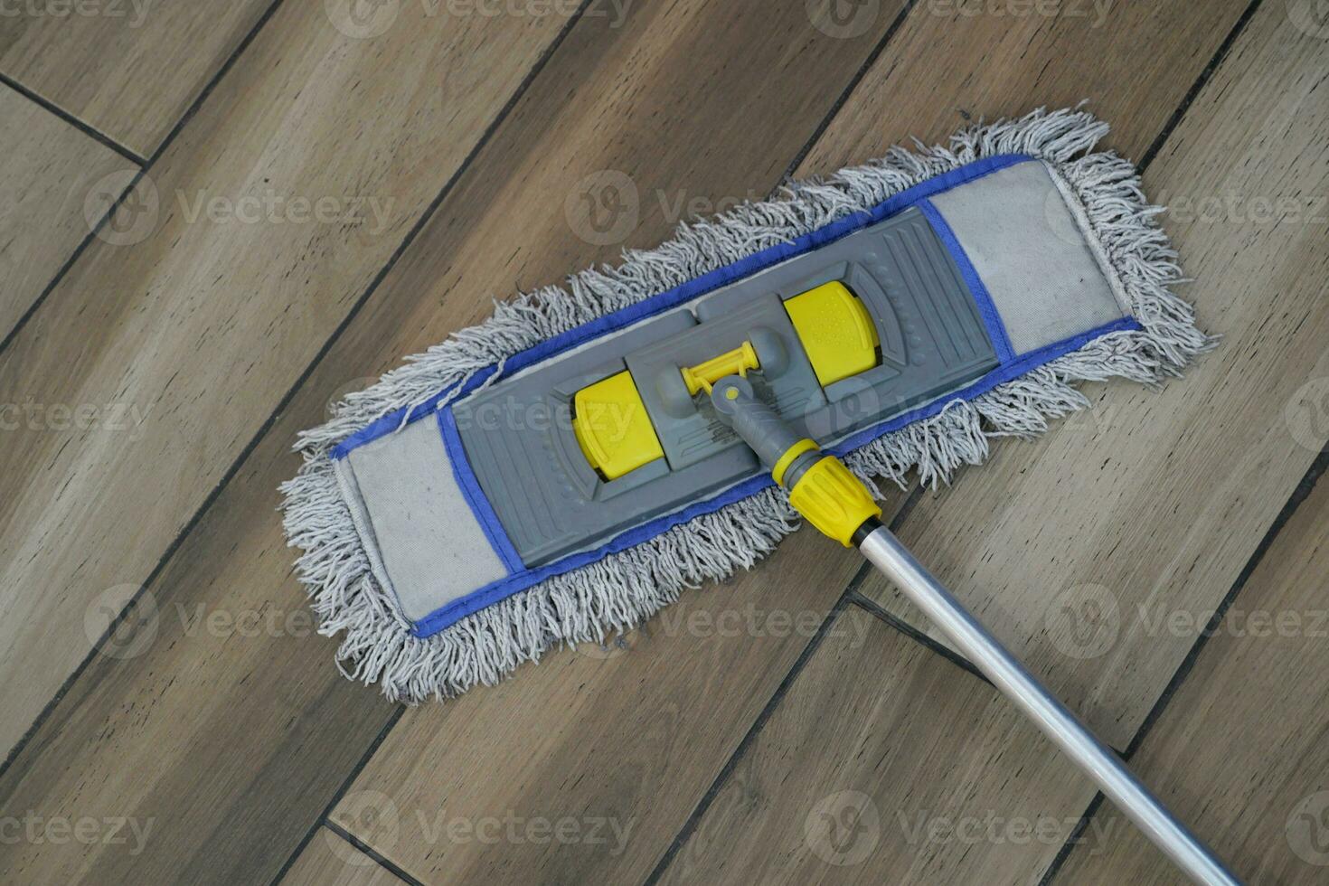 cleaning tiles floor with mop photo