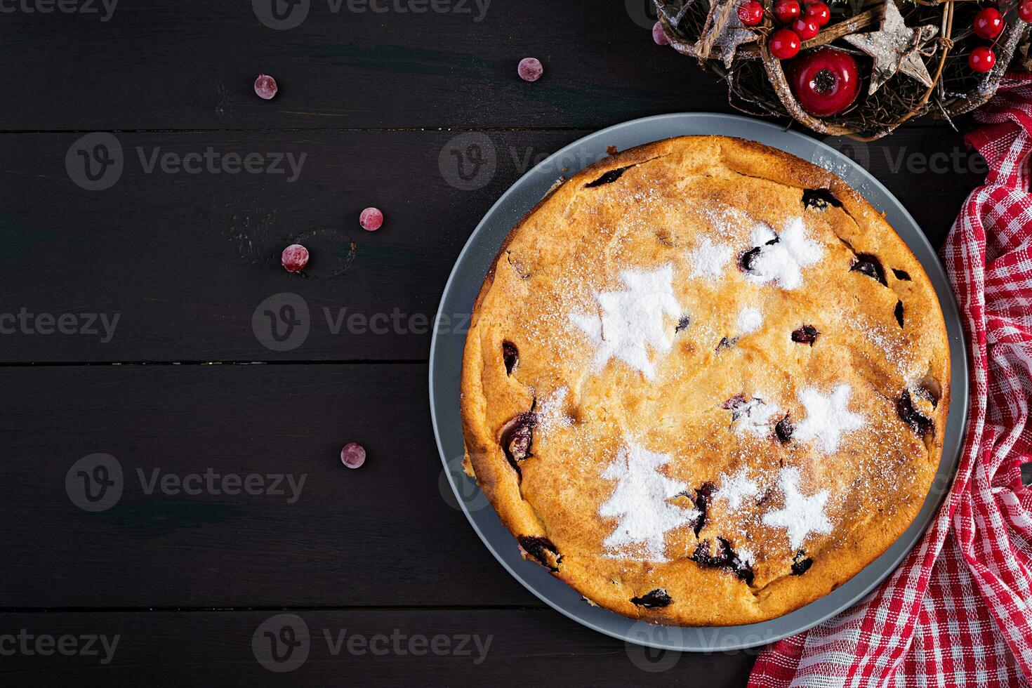 Christmas fruit cake, pudding on dark table. Top view, overhead, copy space. photo