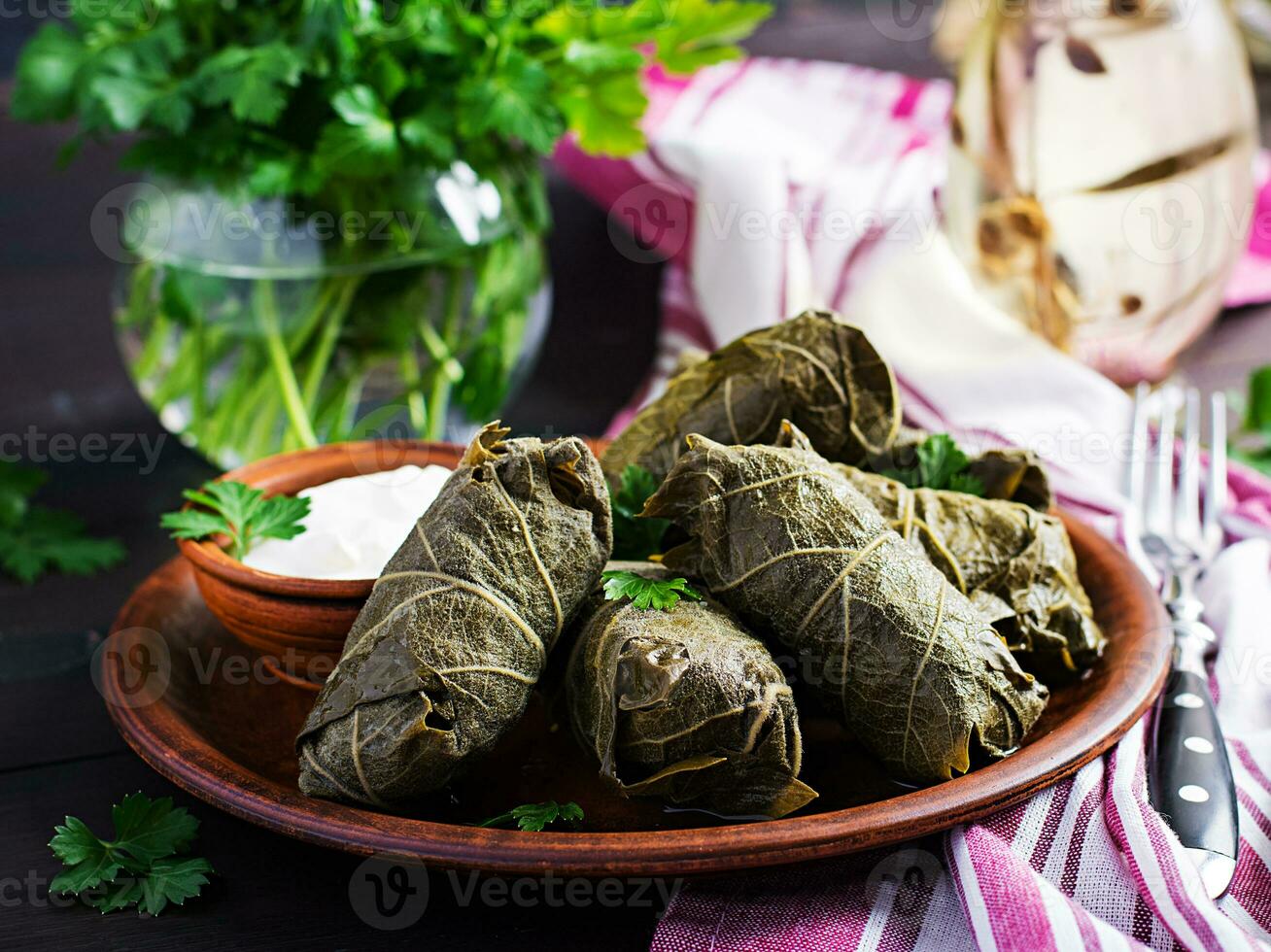 Dolma. Stuffed grape leaves with rice and meat on dark table. Middle eastern cuisine. photo