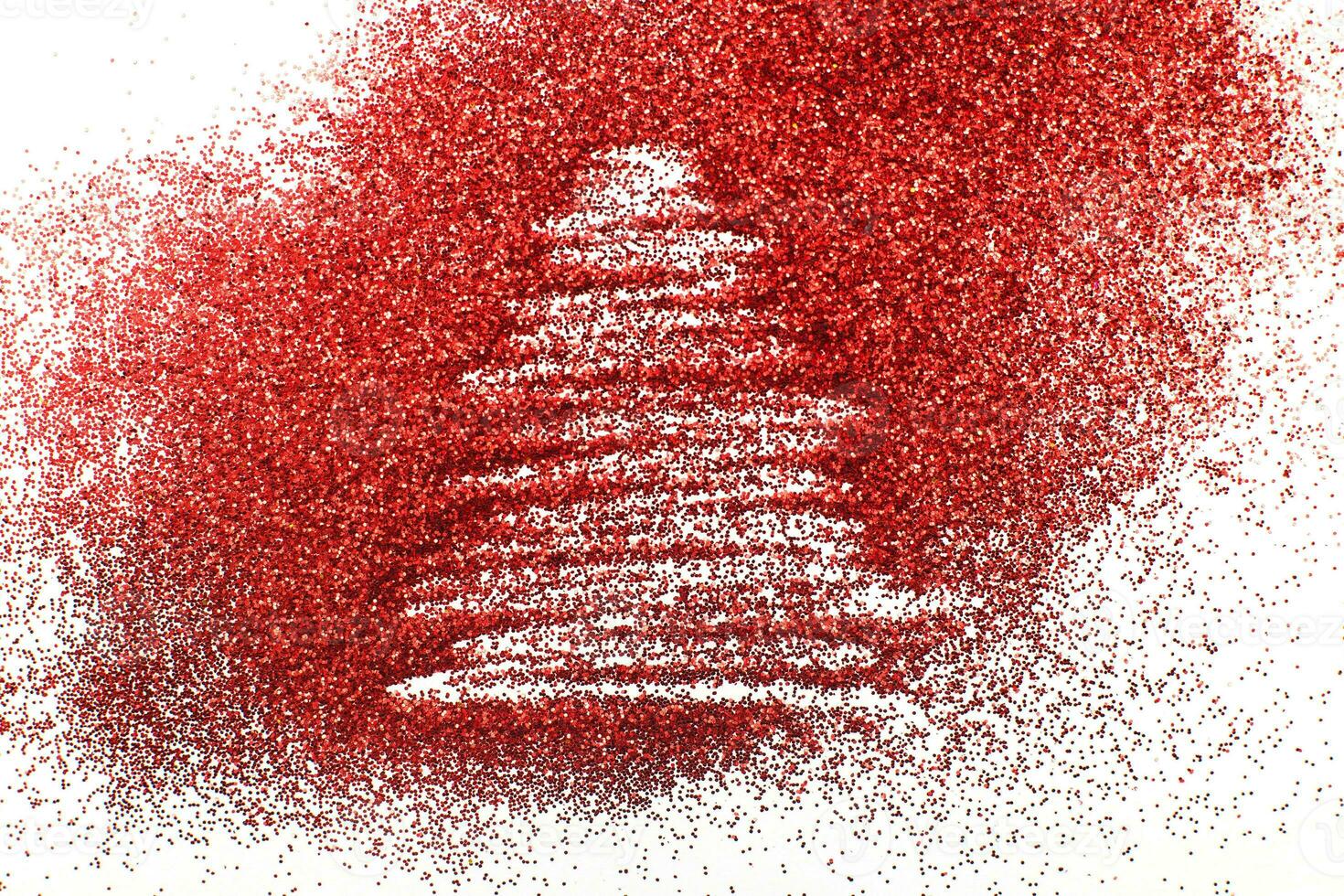 finger drawn christmas tree on shiny red confetti background photo
