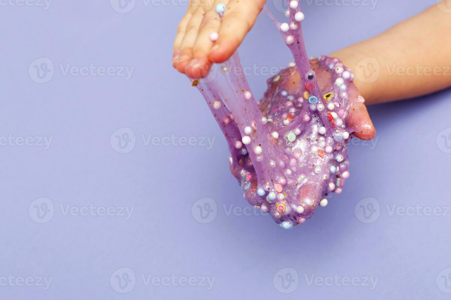 Making slime at home. child stretching colorful slime. DIY concept. photo