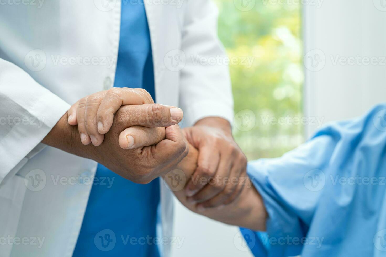 Caregiver holding hands Asian elderly woman patient with love, care, encourage and empathy at nursing hospital, healthy strong medical concept. photo