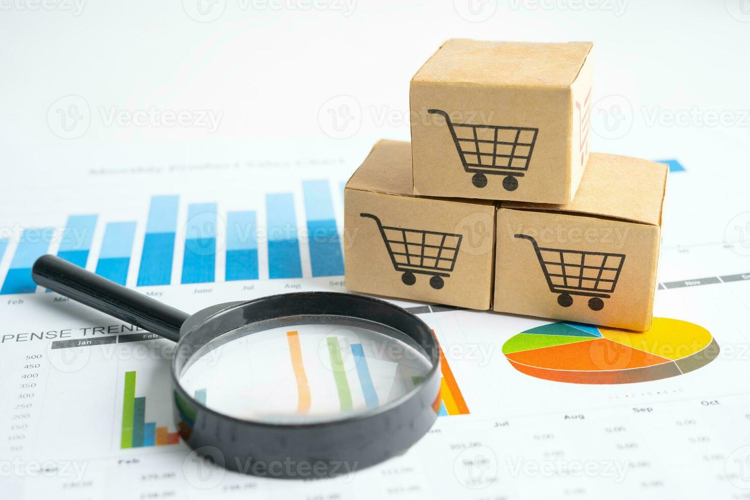 Shopping cart logo on box with magnifying glass on graph background. Banking Account, Investment Analytic research data economy, trading, Business import export transportation online company concept. photo