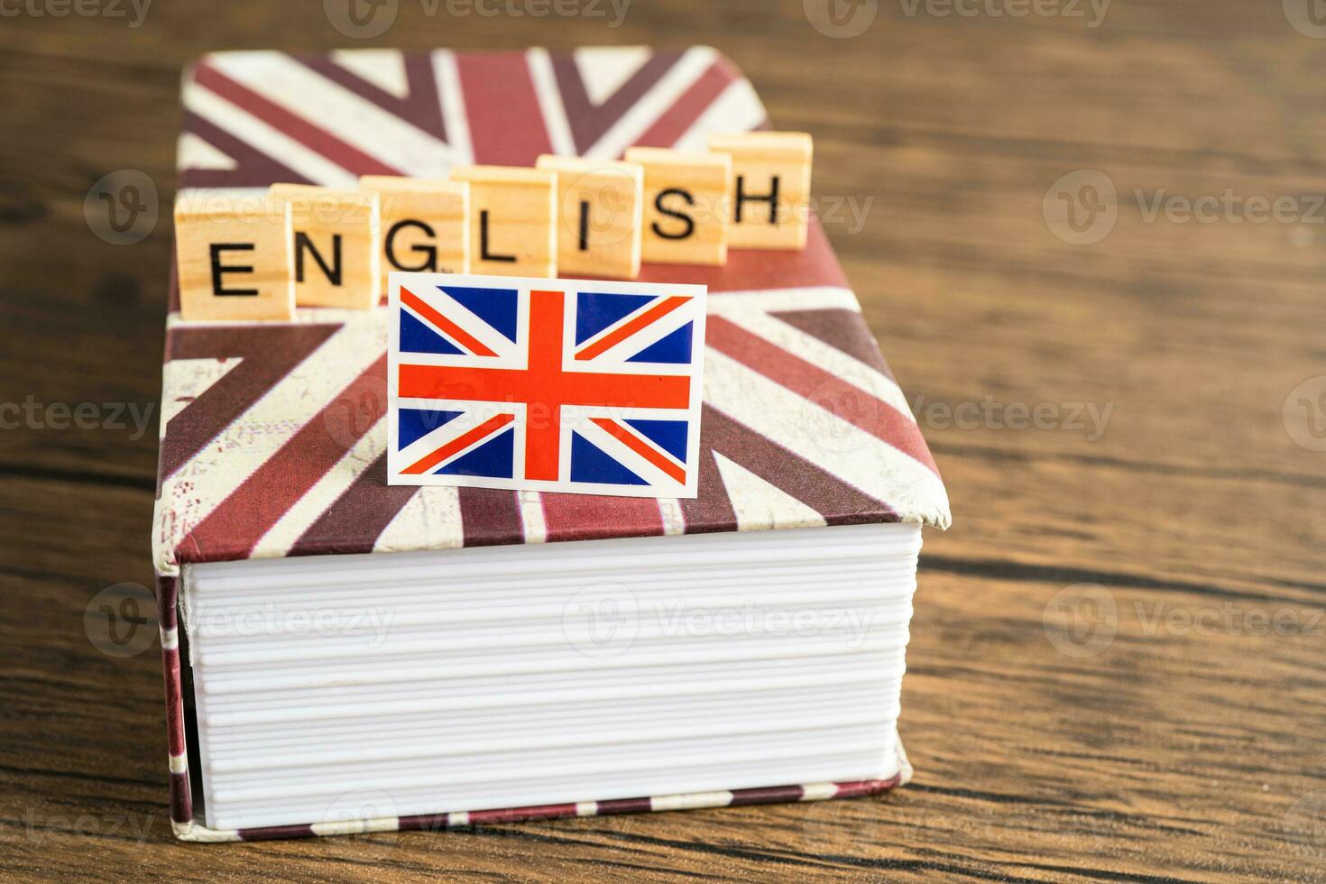 Word English on book with United Kingdom flag, learning English language courses concept. photo