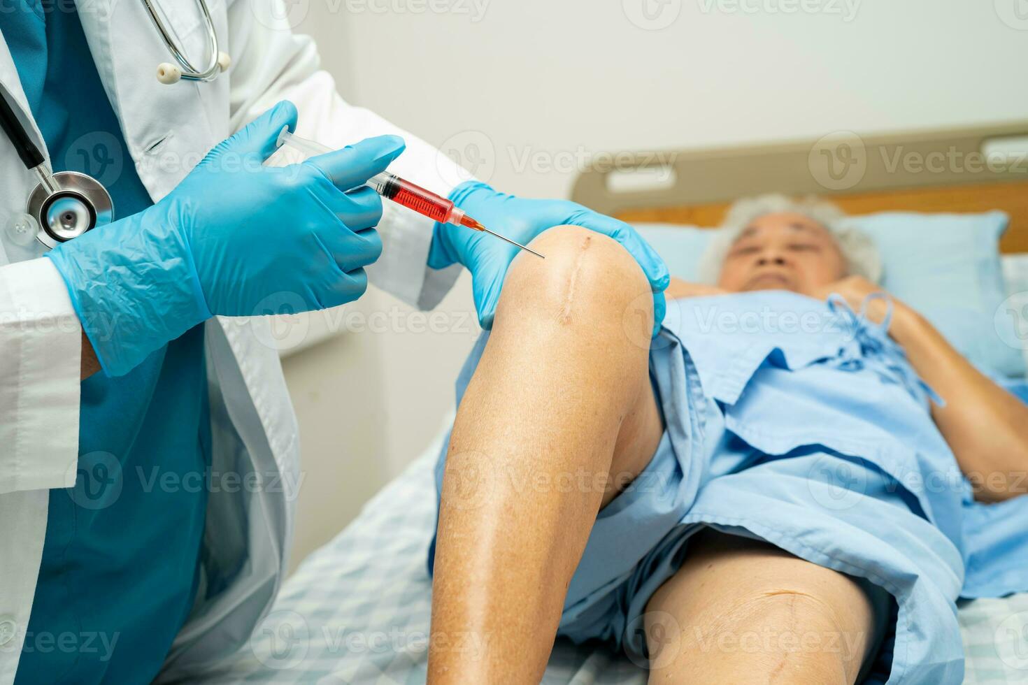 Asian doctor inject Hyaluronic acid platelet rich plasma into the knee of senior woman to walk without pain. photo