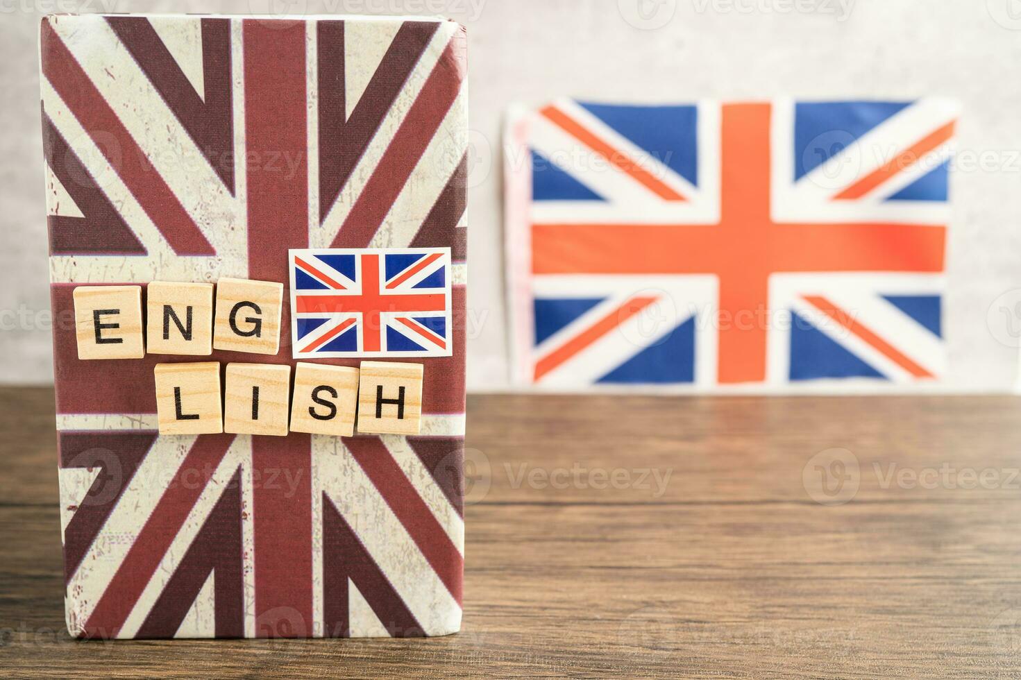 Word English on book with United Kingdom flag, learning English language courses concept. photo