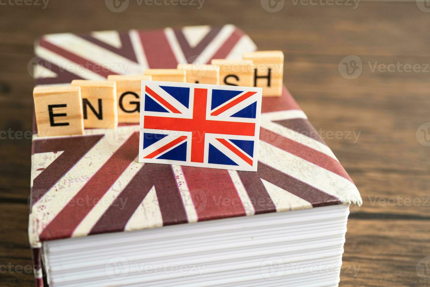 Word English on book with United Kingdom flag, learning English language courses concept. photo