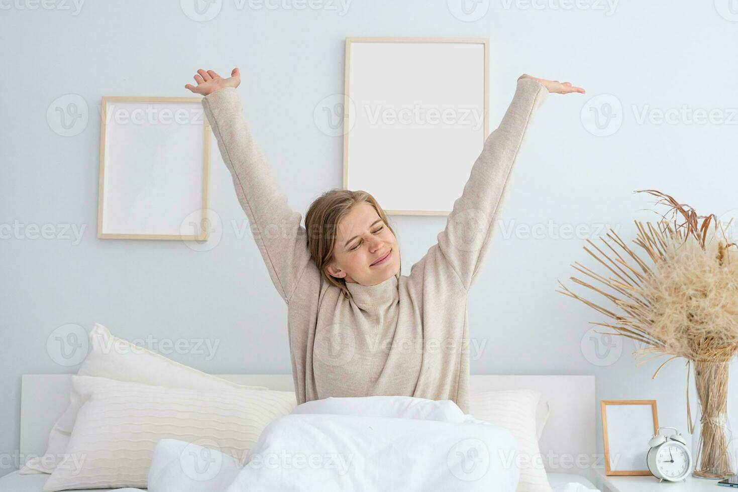 Woman waking up at bed at home photo