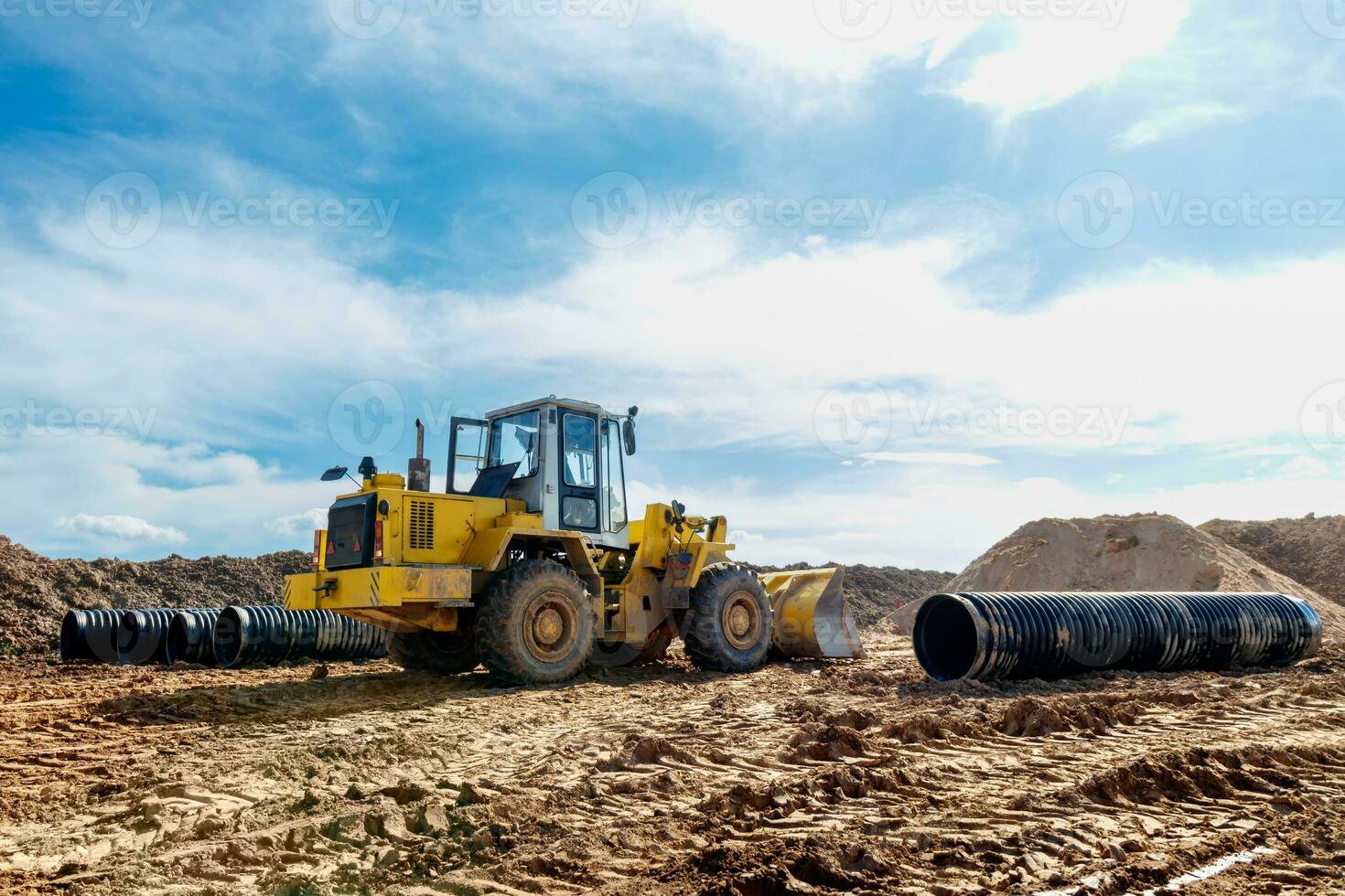 Wheel machine for loading performs work on laying large diameter pipes photo