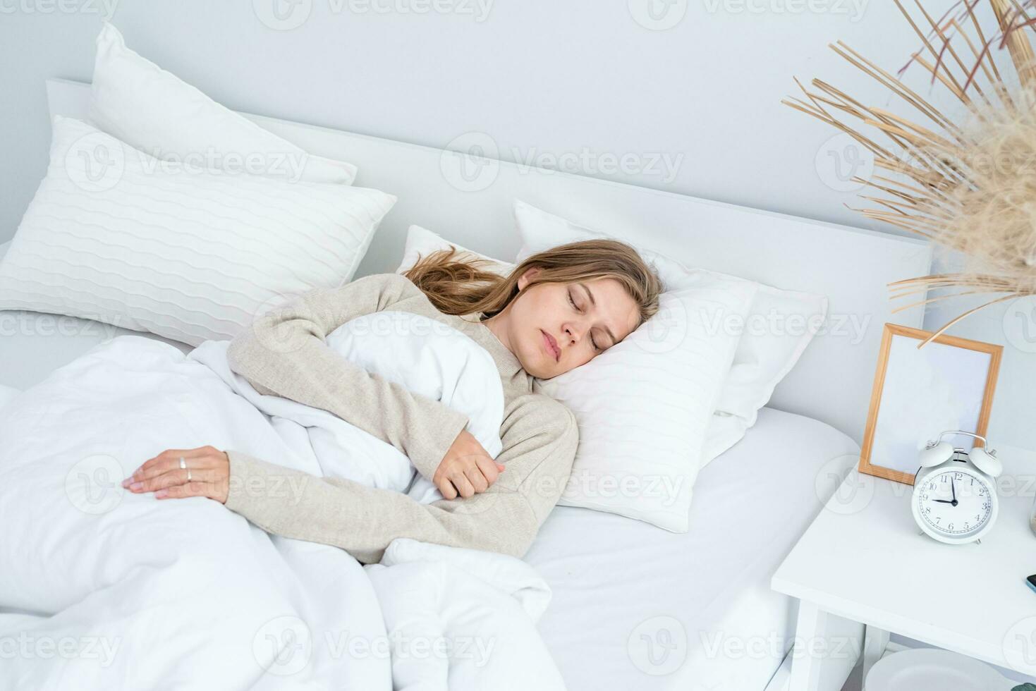 Woman sleeping at bed at home photo