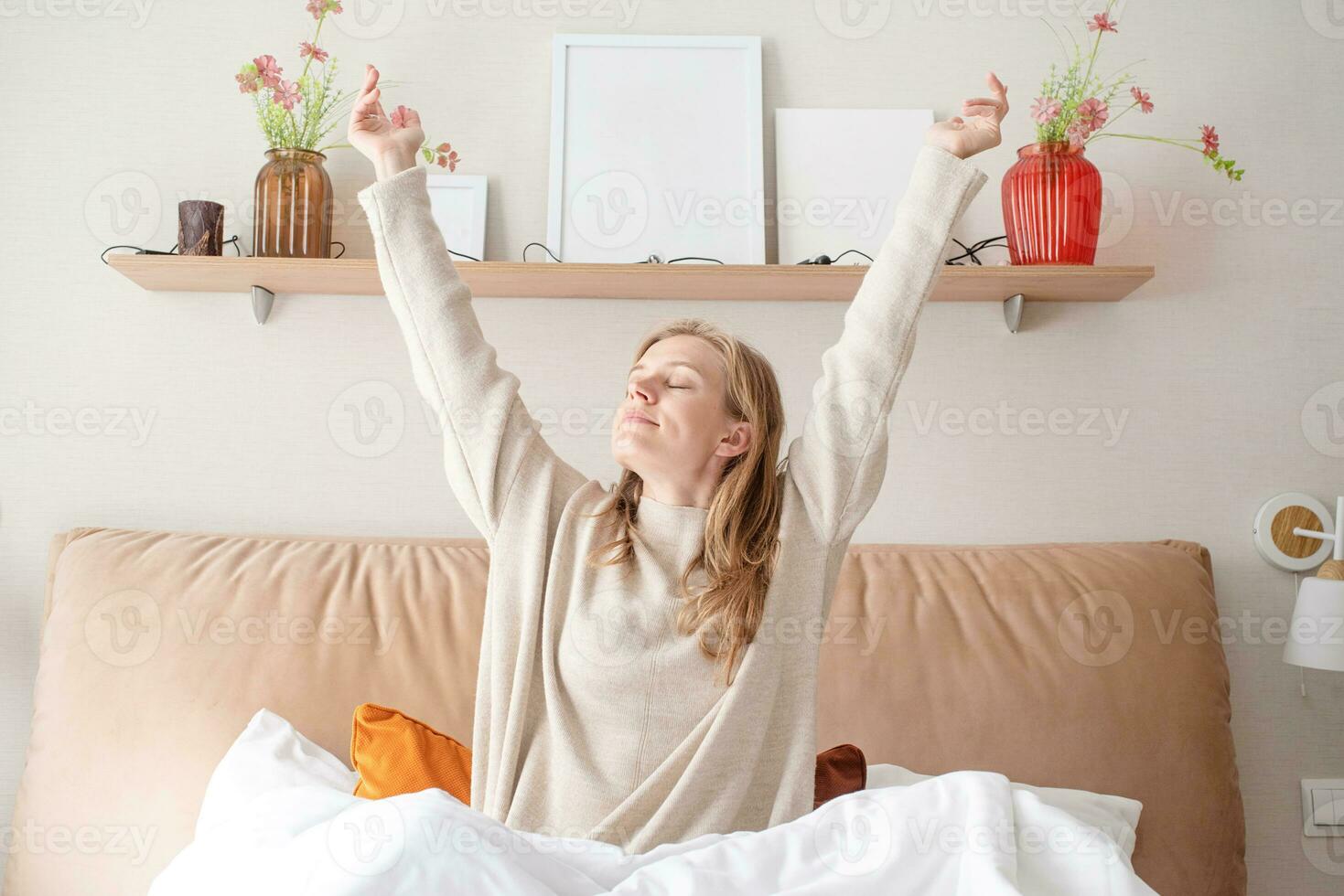 Woman waking up at bed at home photo