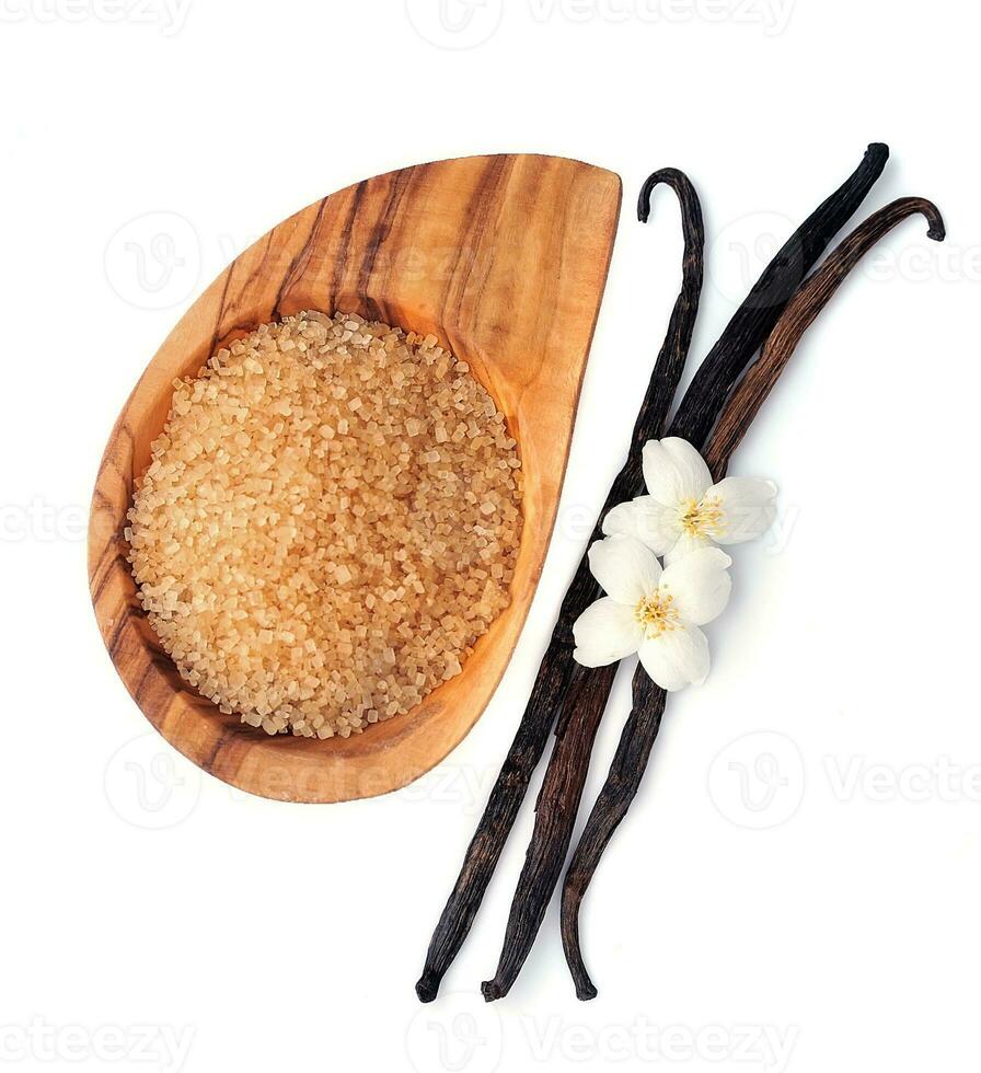 Vanilla sugar and sticks with flowers . photo