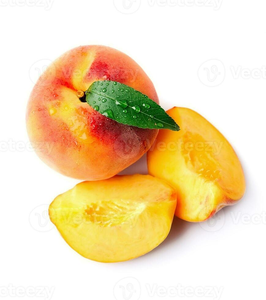 Ripe peach with peach slices . photo