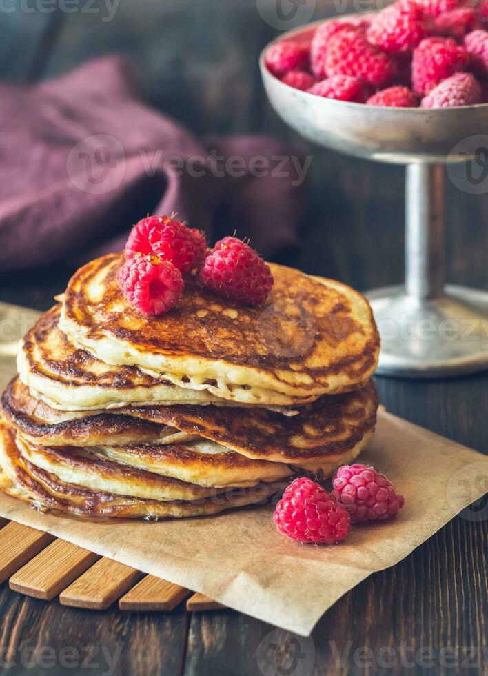 Stack of pancakes with fresh raspberries photo