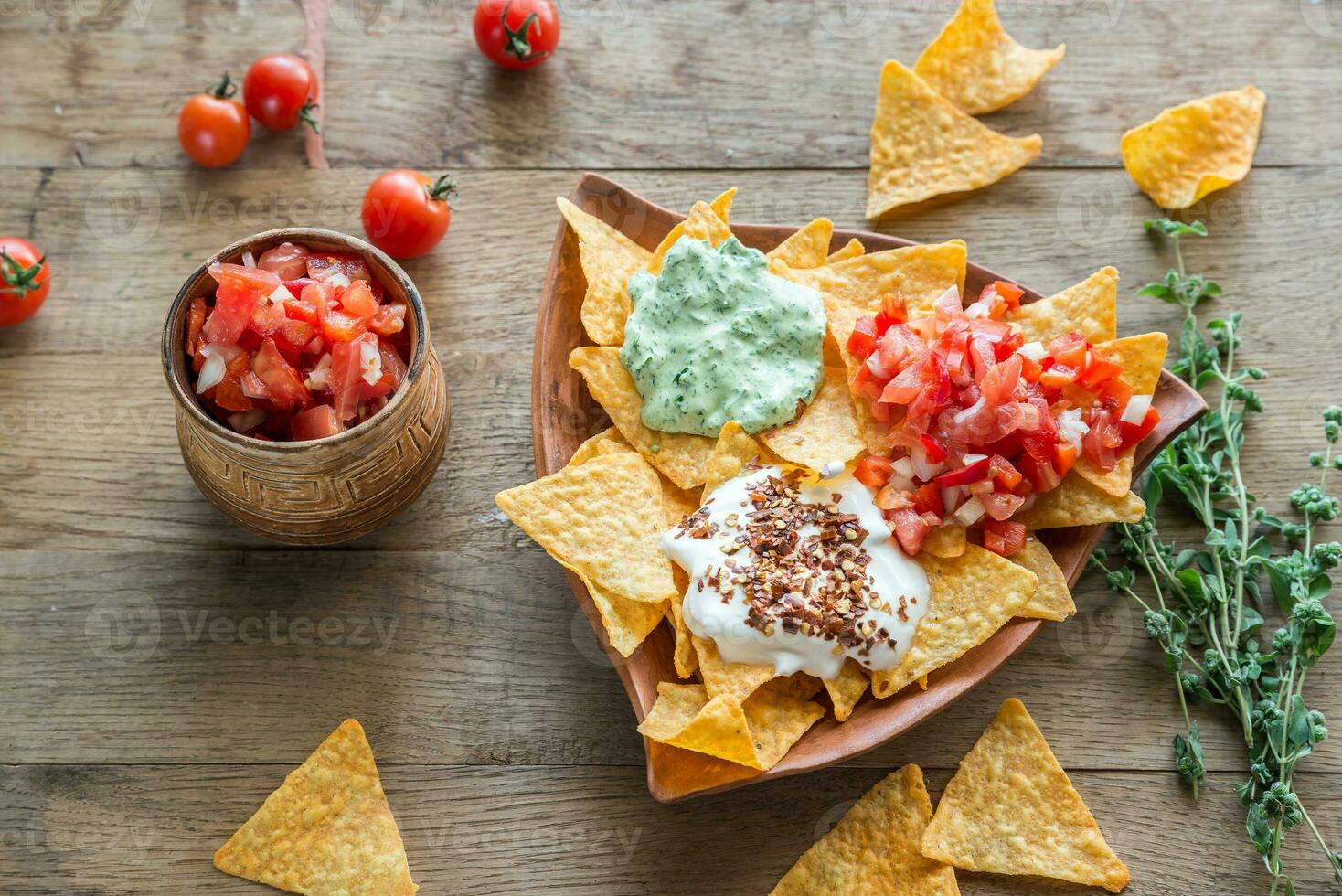 Cheese nachos with different types of sauce photo