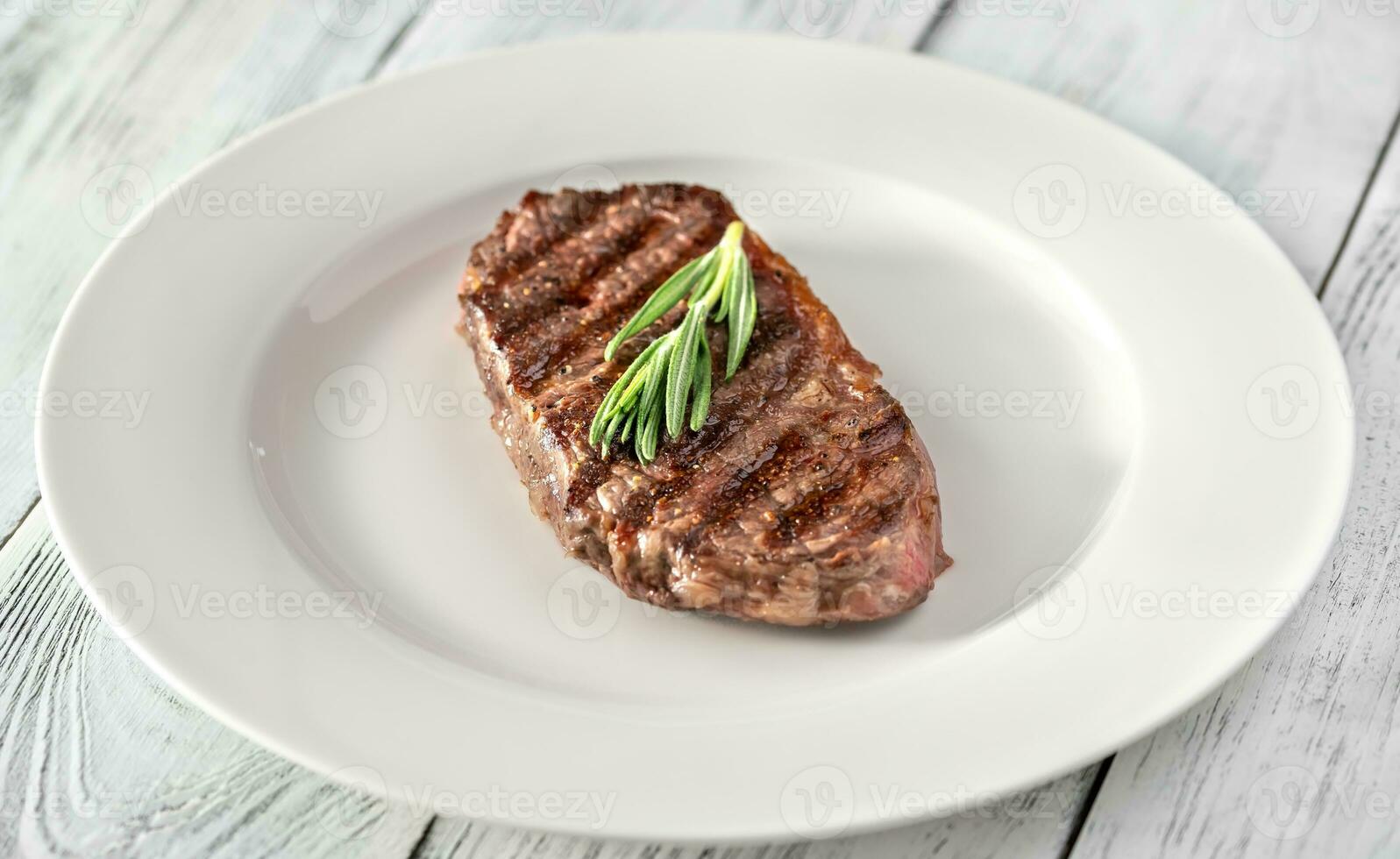 Beef steak with fresh rosemary photo