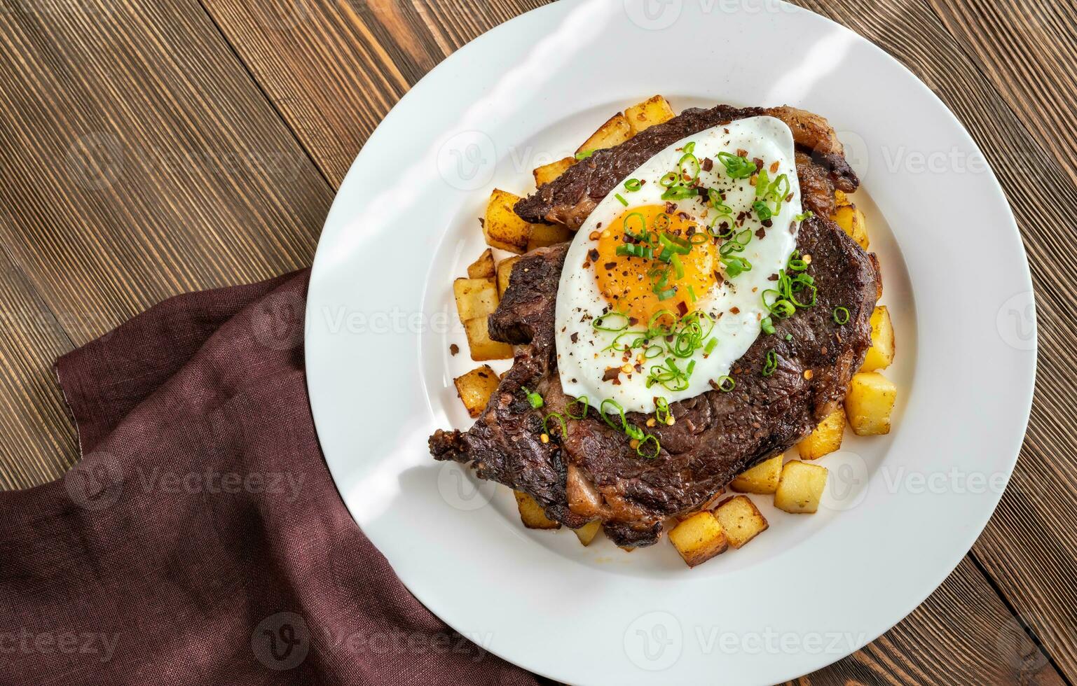 Beefsteak with fried egg photo