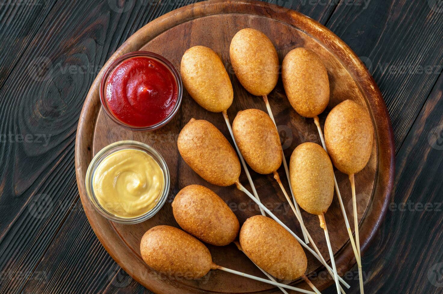 Corn dogs with different dips photo