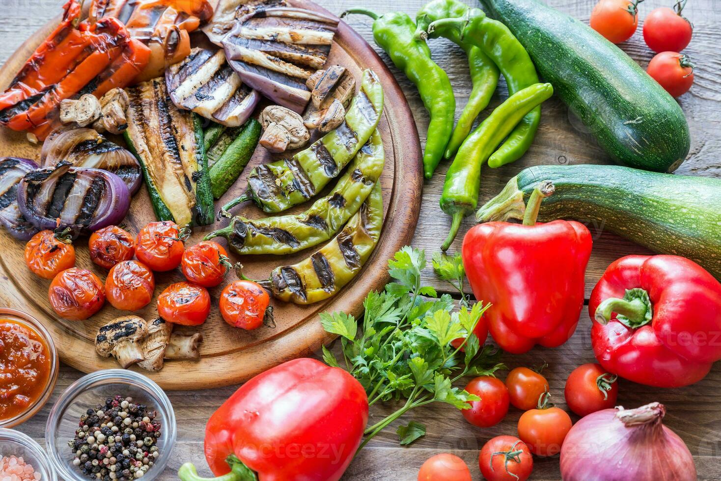 Grilled and fresh vegetables on the wooden board photo