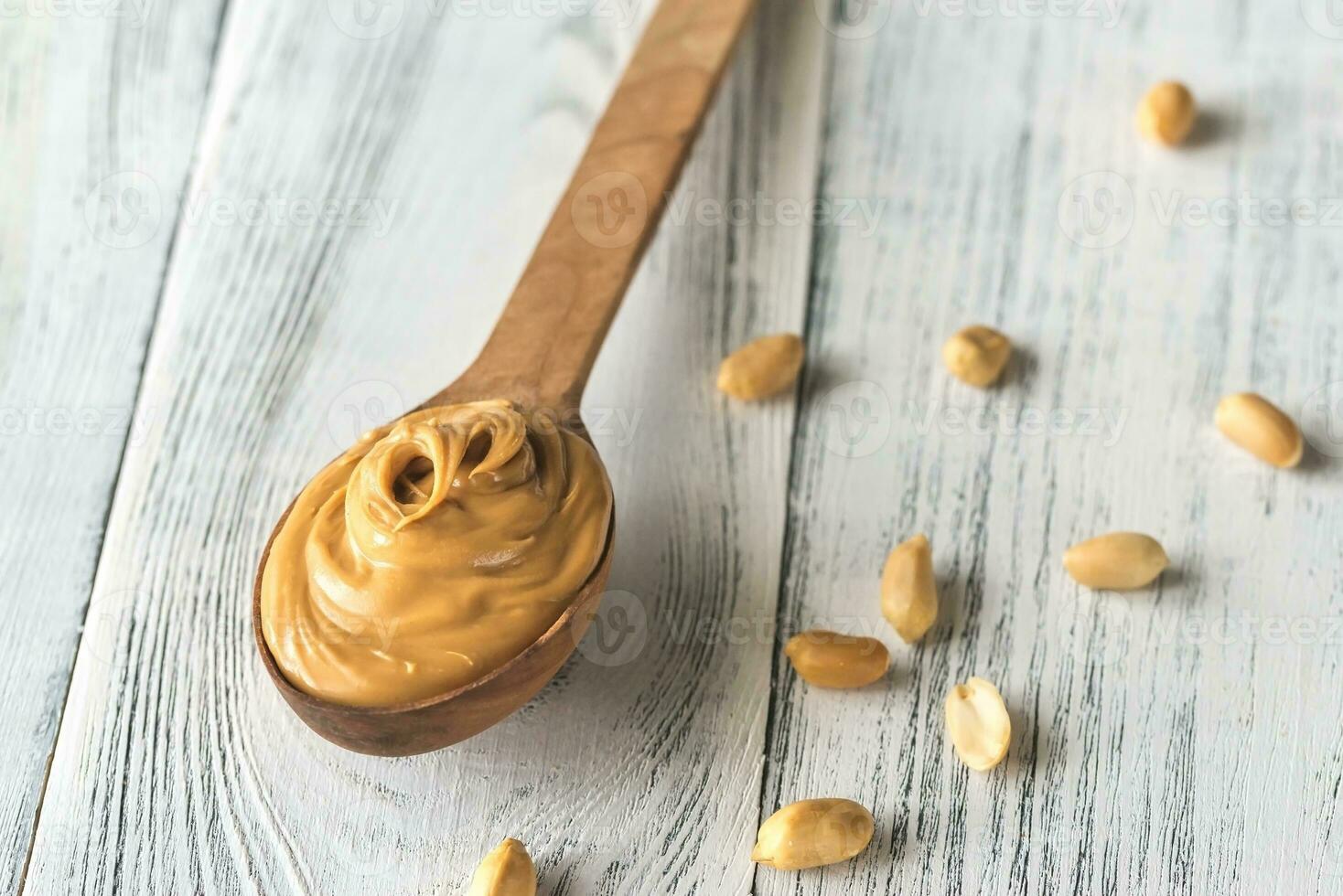 Wooden spoon of peanut butter photo