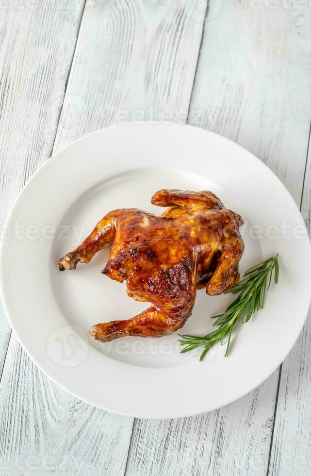 Roasted chicken on the white plate photo