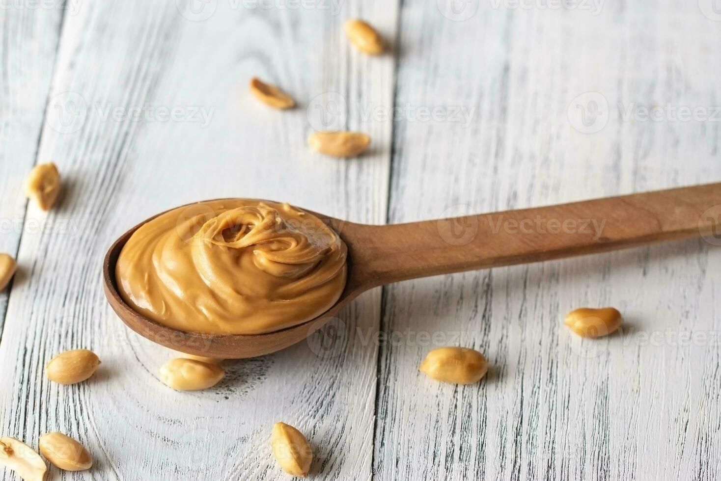 Wooden spoon of peanut butter photo