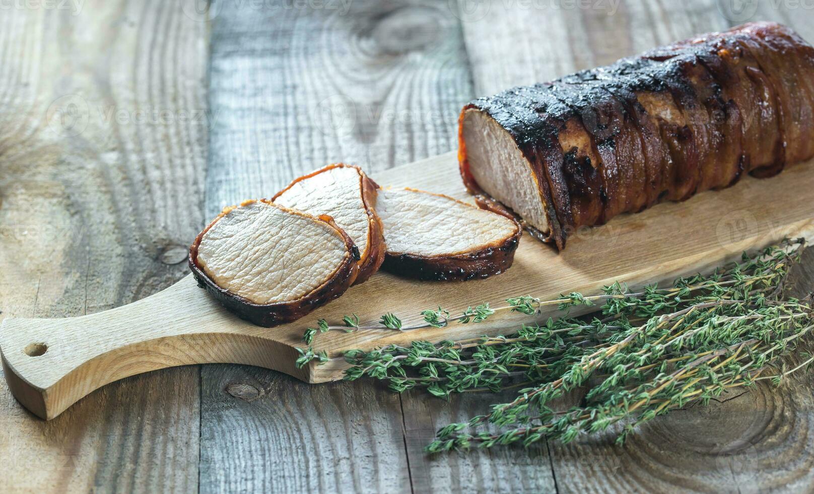 Pork loin wrapped in bacon photo