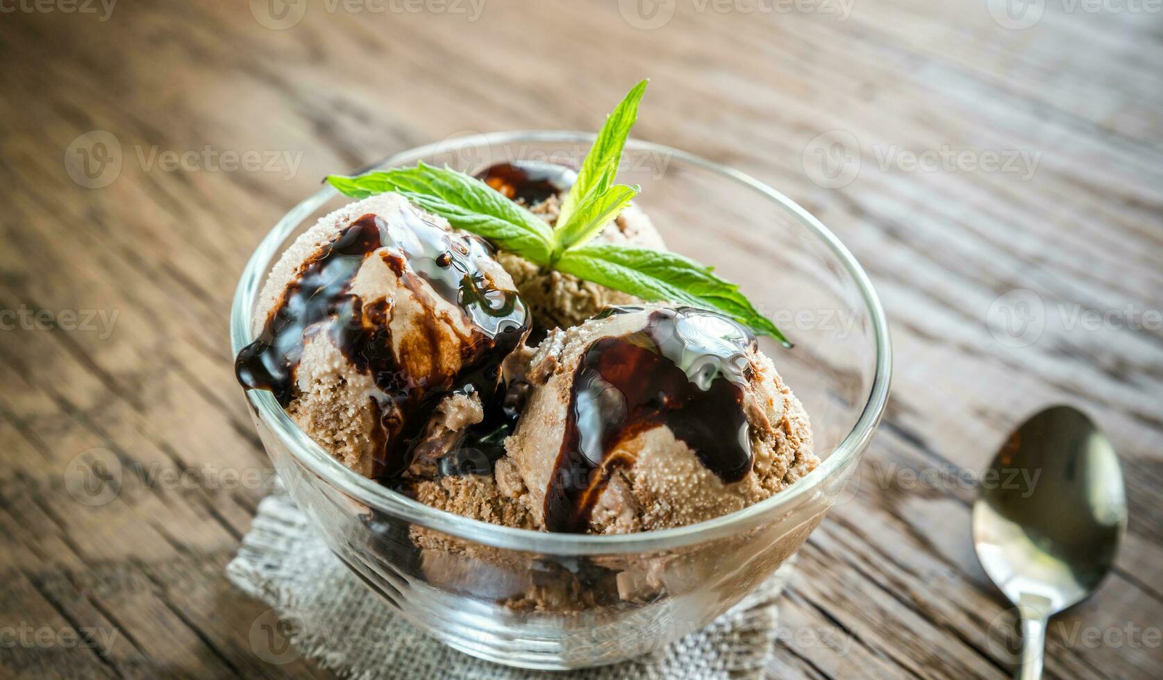 Chocolate ice cream with dessert topping photo