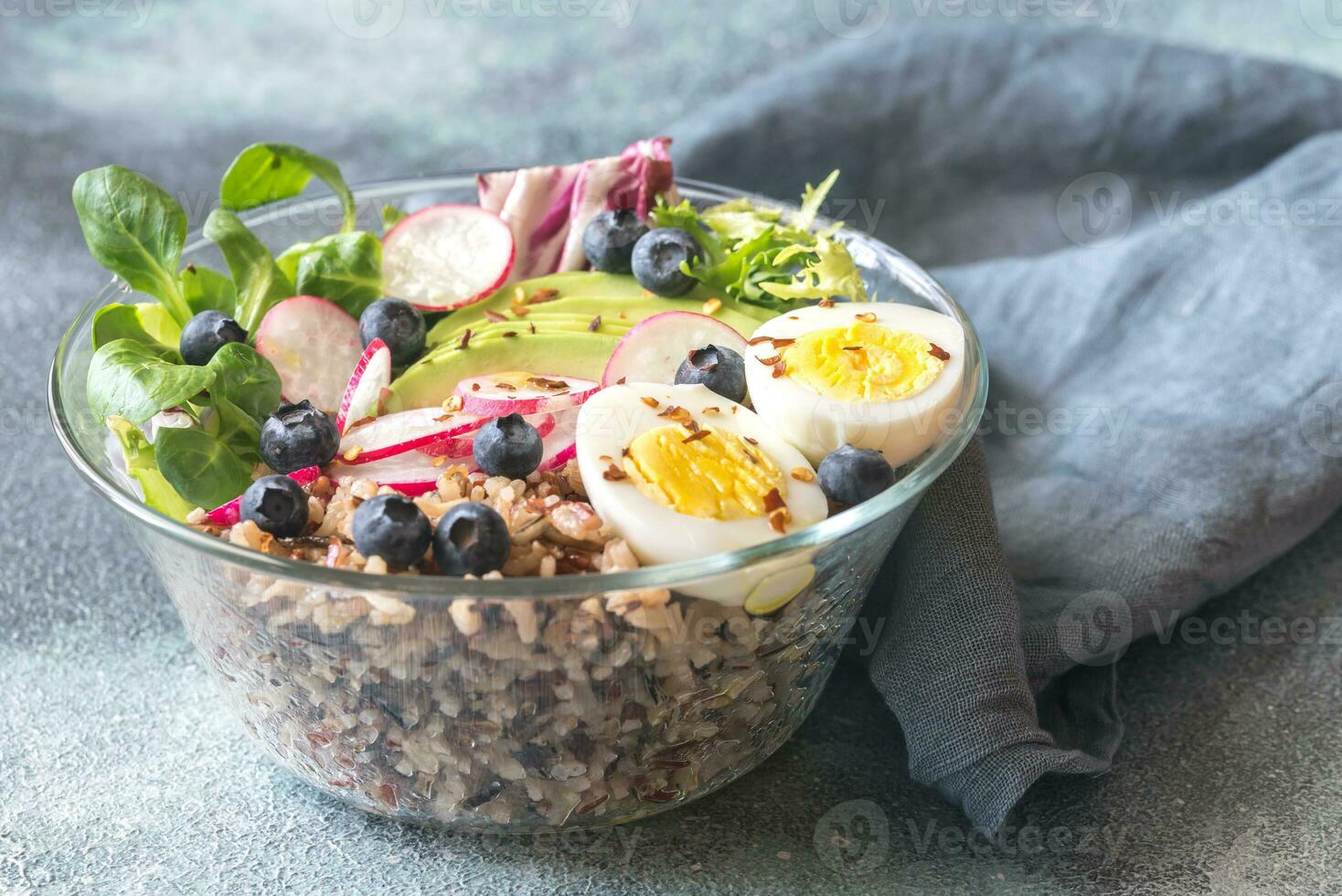 Bowl of wild rice with avocado, egg and lettuce photo