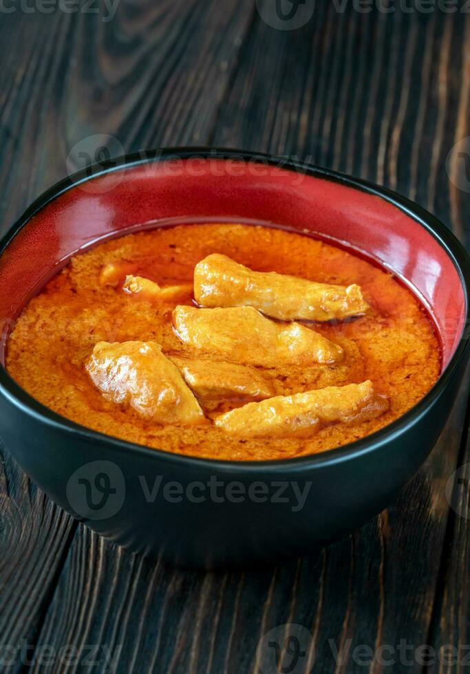 Bowl of Thai red chicken curry photo