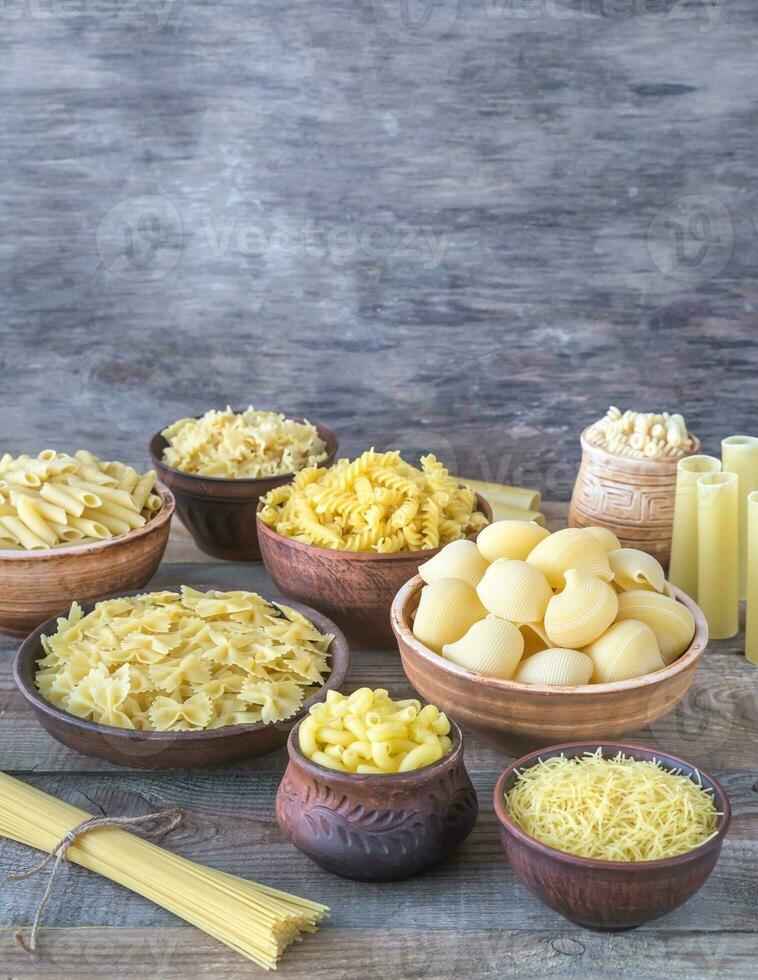 Various types of pasta on the white background photo